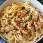 Creamy Cajun chicken pasta served in a white bowl with parsley garnish and penne pasta.